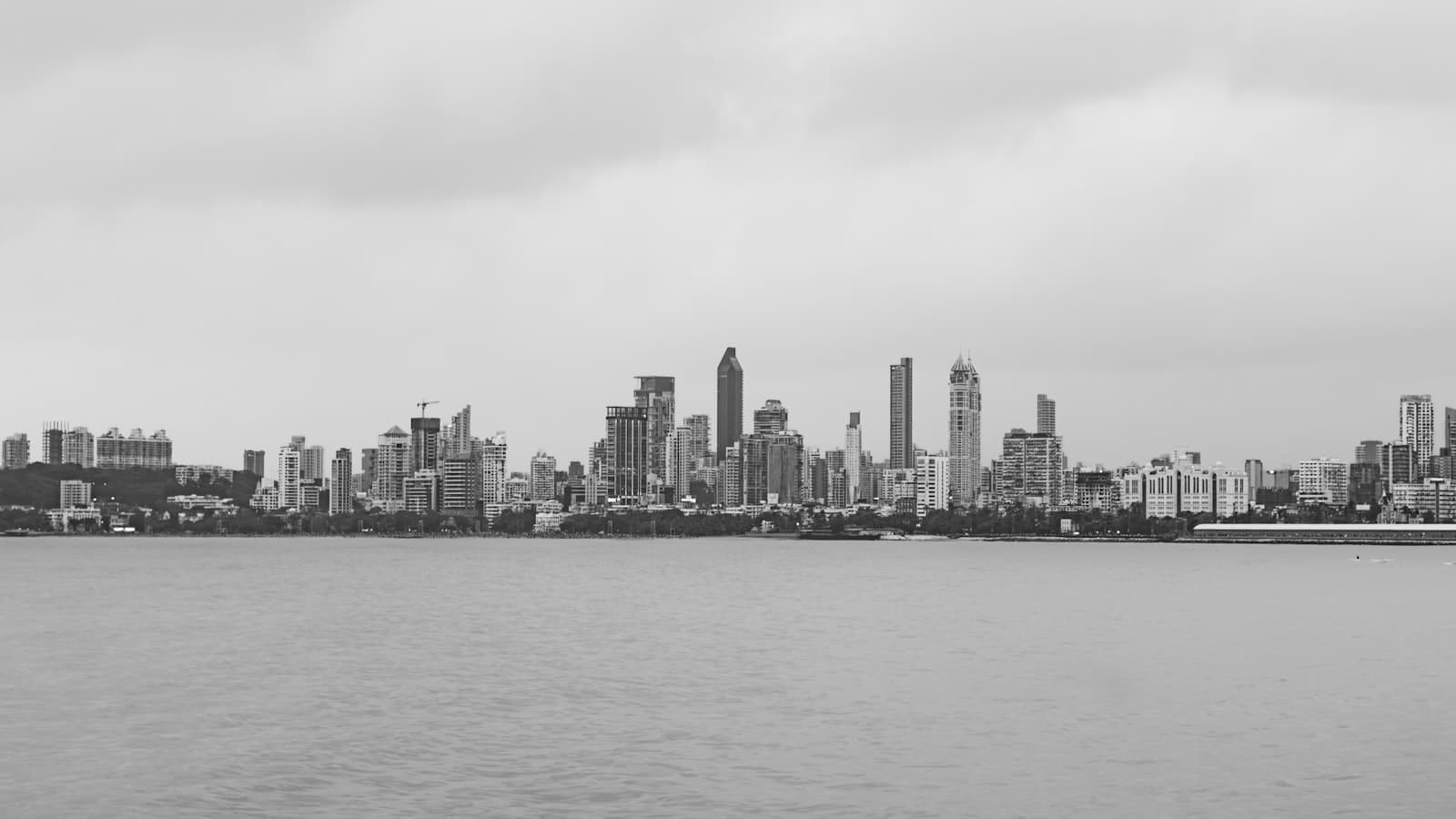 Unobstructed city skyline view through thin invisible grill cables on a high-rise balcony